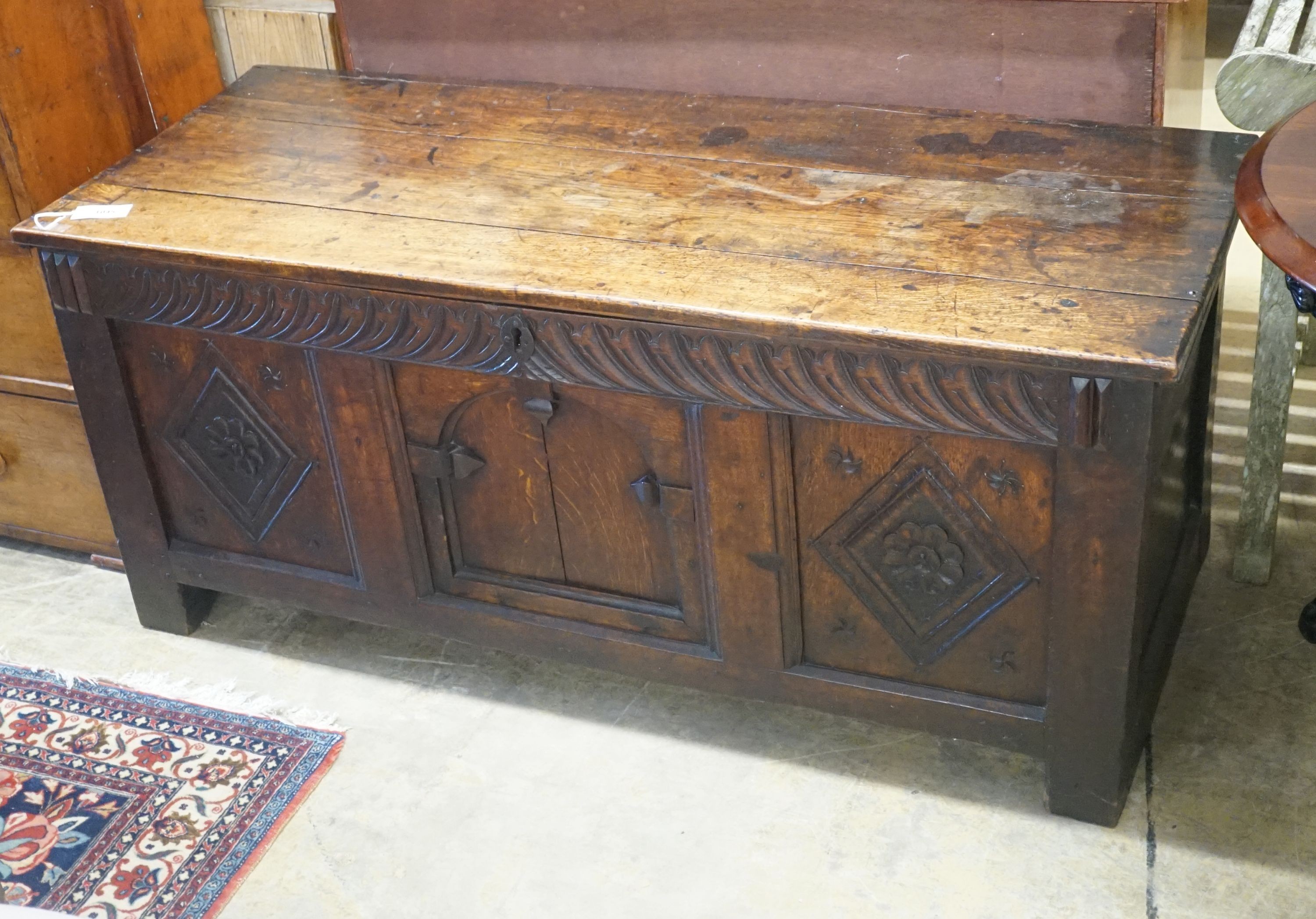 An 18th century carved oak coffer, width 141cm depth 56cm height 62cm